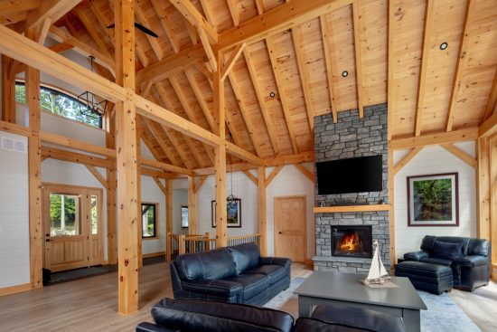 modern bungalow house design lakeside cottage timber frame project Cottage Calm Normerica interior great room fireplace